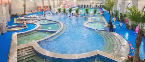 An indoor swimming pool with multiple lanes and a central island.