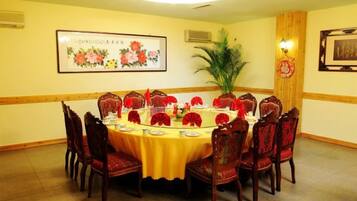 A conference room with a round table, chairs, and floral decorations.