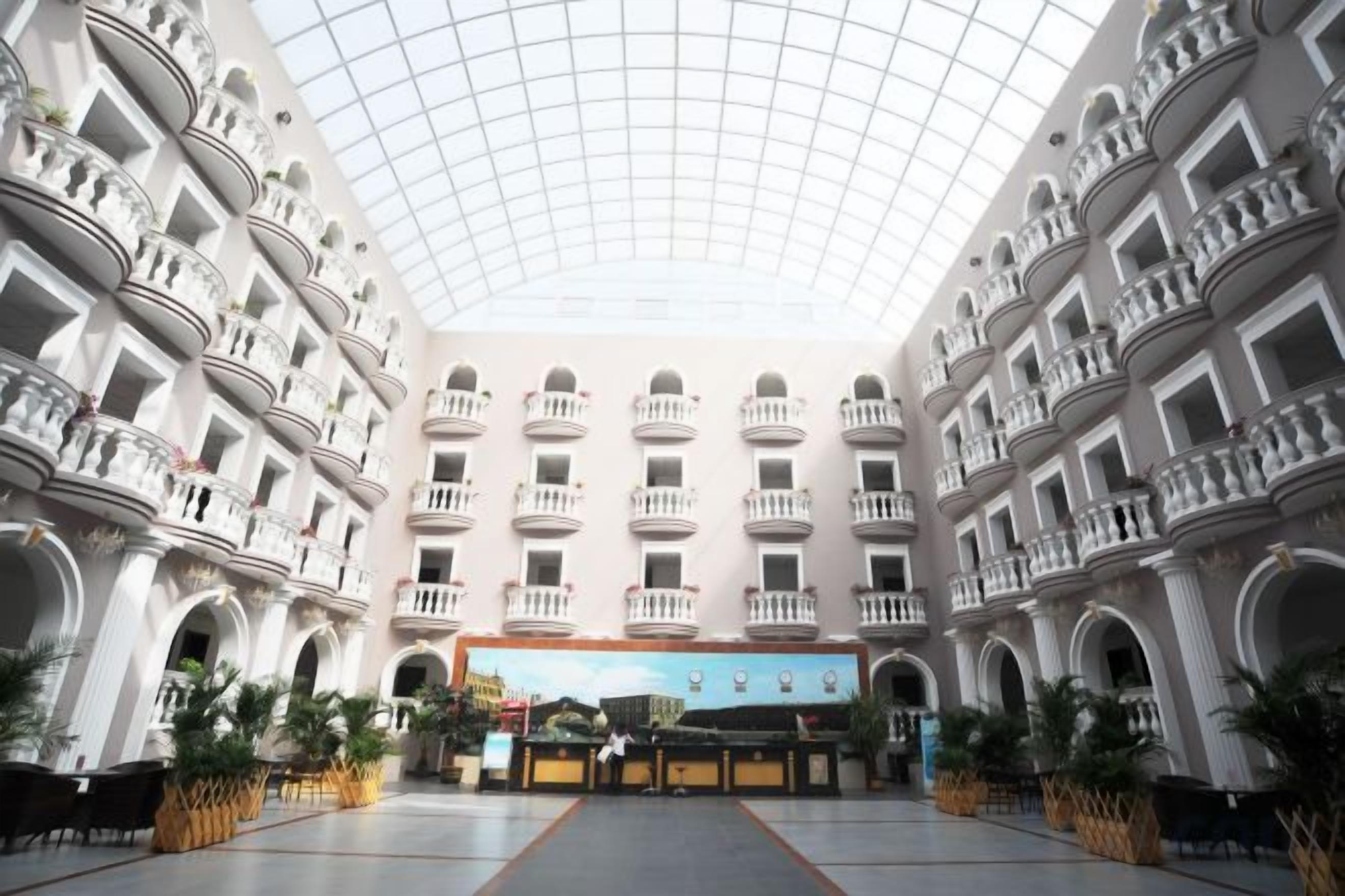 A spacious atrium with a high ceiling and multiple balconies.
