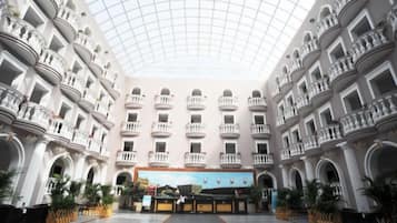 A spacious atrium with a high ceiling and multiple balconies.