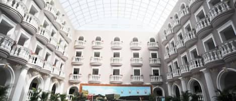 A spacious atrium with a high ceiling and multiple balconies.
