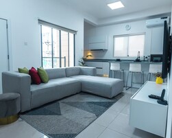 Luxury Suite | Living area | 65-inch Smart TV with cable channels, Netflix, pay movies