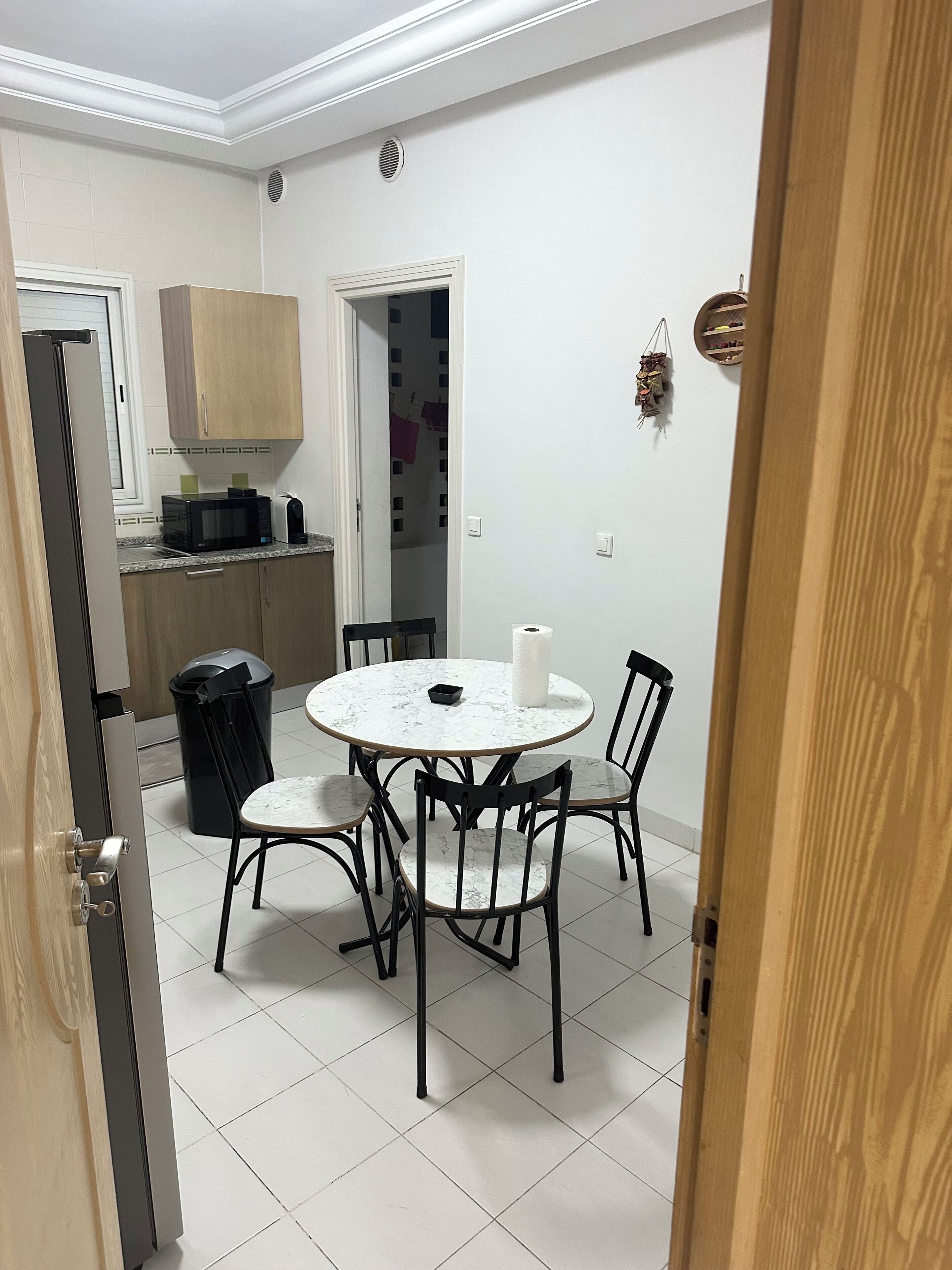 A compact kitchen with a microwave, toaster, and cabinets.