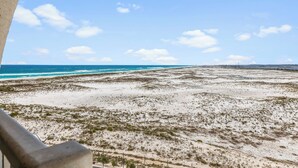A coastal landscape with a beach and ocean.