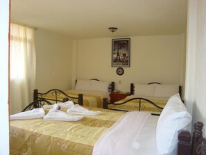 A hotel room with two beds, a poster of the Eiffel Tower, and a bedside table with a lamp. - Hotel Los Angeles  (Tulancingo)