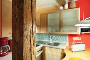 A kitchen with wooden cabinets, a sink, and a countertop.