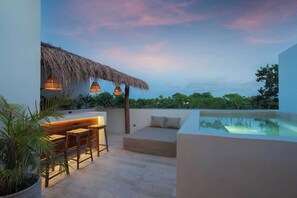 A rooftop terrace with a pool, seating area, and thatched roof structure. - Itza Maya Penthouse Sunny Rooftop Aldea Zama (Tulum)