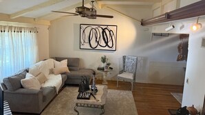 A living room with a grey sofa, a coffee table, and a painting on the wall. - Un Lugar Para Compartir en Familia (Allentown)