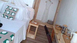 A cozy bedroom with a bed, bedside table, and a small wooden desk with a chair. - Dilara Huzur Motel (Ayvacik)