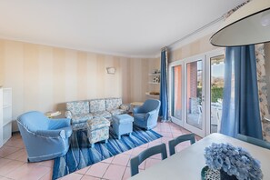 Apartment, Lake View | Living area | 35-inch flat-screen TV with digital channels