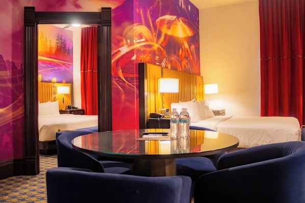 A hotel room with two beds, a glass table, and a large mirror. - Rocksino by Hard Rock Deadwood (Deadwood)