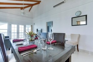 Enjoy meals in style with a spacious dining table and comfortable seating for four.