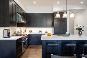 Enjoy cooking in this well-equipped kitchen with a central island sink, oven, and stovetop.