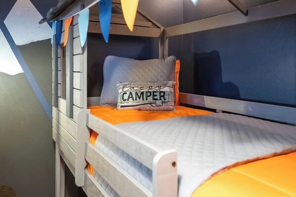 A bunk bed with a pillow that reads "happy camper" and a window with a view of the sky. - 10BR Coastal Style Dream Villa 23108 (Davenport)