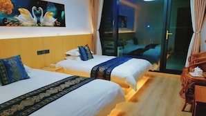 A hotel room with two beds, a wooden headboard, a painting of swans, a glass door, and a small table with a teapot.