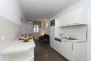 Compact kitchen with microwave and dishwasher, perfect for preparing meals.