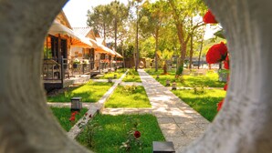 A circular view of a pathway lined with trees and a building with a white roof. - Agva Casa Rosa Bungalov Otel (Sile)