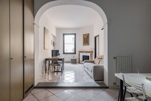 Apartment | Living area | 30-inch flat-screen TV with digital channels - Torre dell'Orologio Apartment by Wonderful Italy (Bologna)