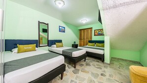 A hotel room with two beds, a mirror, a wardrobe, and a small table. - HOTEL EL BOSQUE ARMENIA (Armenia)