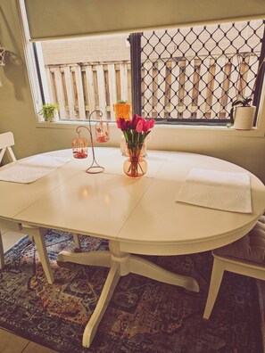 Enjoy meals in this cozy room with a dining table, comfortable chair, and a beautiful view.