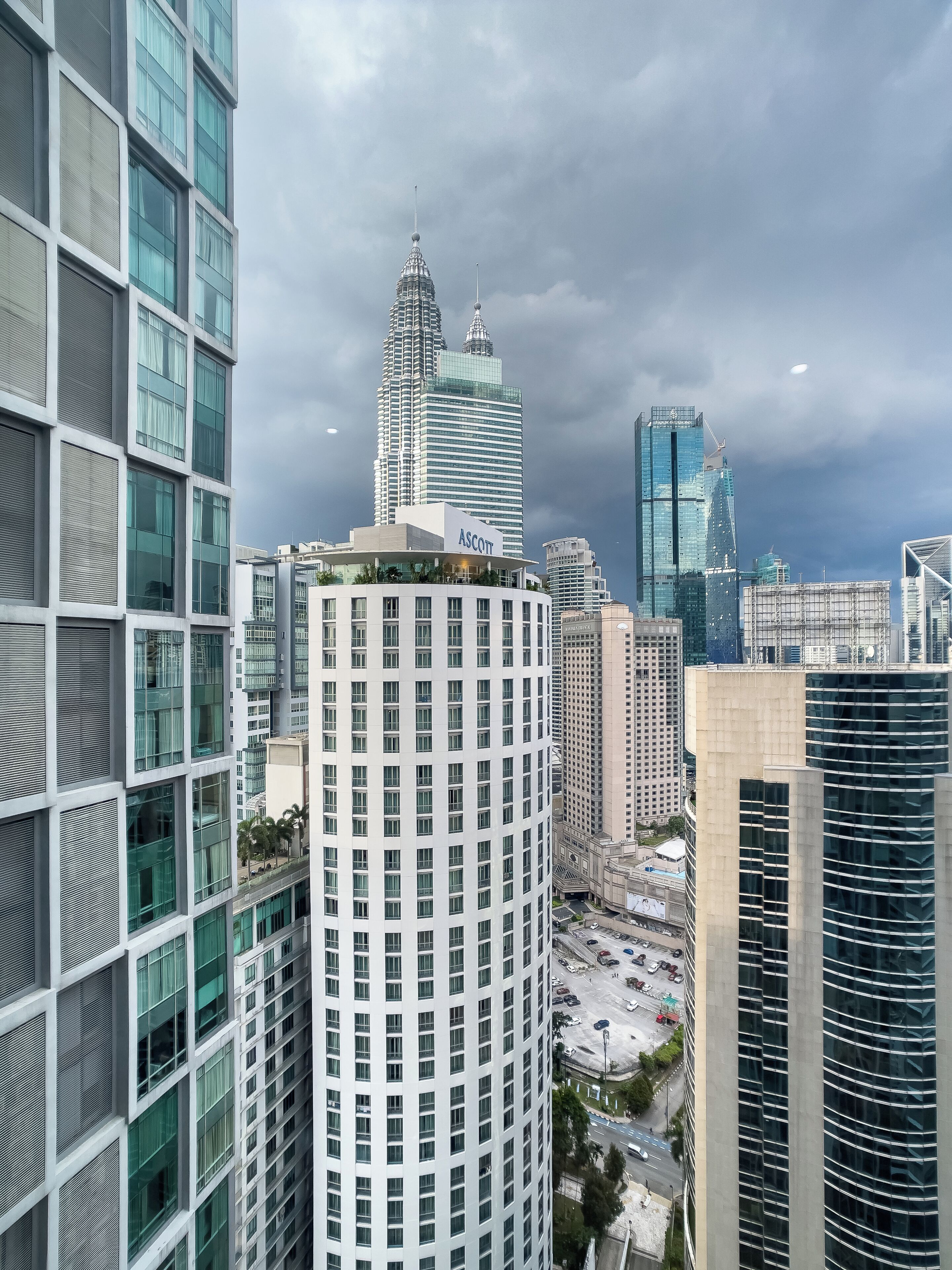 A high-rise building with a modern architectural design, featuring a prominent tower with a spire.