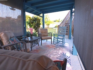 A covered outdoor seating area with a table, chairs, and a potted plant. - Kestrel - Best location in Nassau, Kestrel Bahamas Vacation Rental (Nassau)