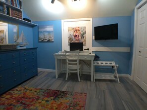 A room with a desk, chairs, a bookshelf, and a television. - Kestrel - Best location in Nassau, Kestrel Bahamas Vacation Rental (Nassau)