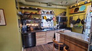 A compact kitchen with wooden cabinets, a built-in microwave, and a ceiling fan. - 10 minutes walk 2 "Everything Frederick", OSP, Sports Events, Sleeps up to 8 (Frederick)