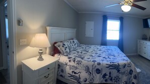 A bedroom with a bed, a nightstand, a dresser, a chair, a TV, and a ceiling fan. - Charming pet-friendly, beach home near Bethany Beach- great local attractions.  (Ocean View)