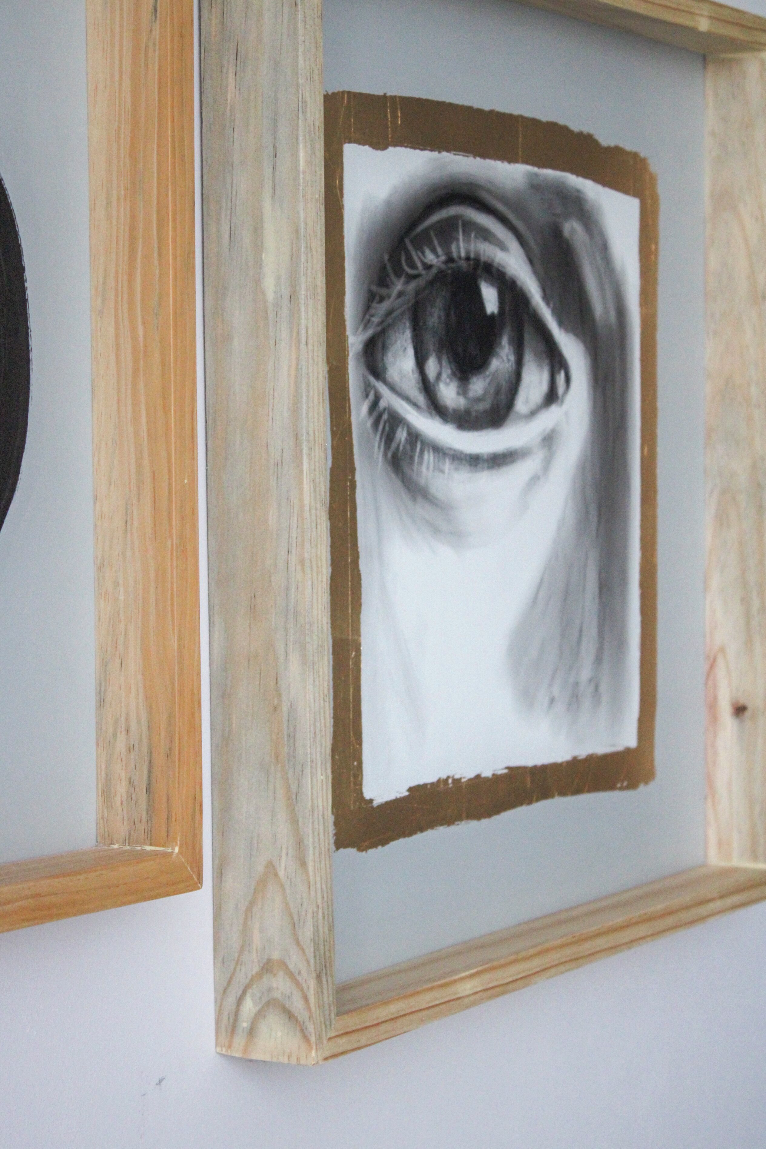 A framed drawing of an eye.