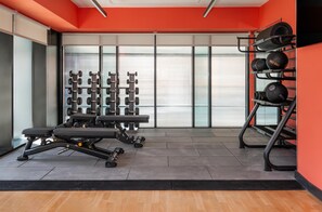 A gym with exercise equipment, including dumbbells and a bench. - Hyatt Place Leeds (Leeds)