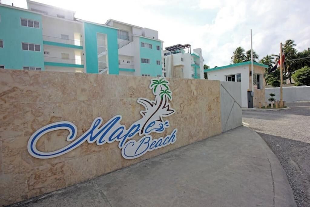 A sign for Maple Beach with a palm tree logo.