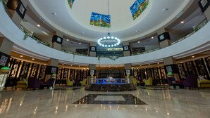 A spacious lobby with a central fountain, multiple seating areas, and a panoramic ceiling view. - Go Egypt Luxe Living Apartments (Hurghada)