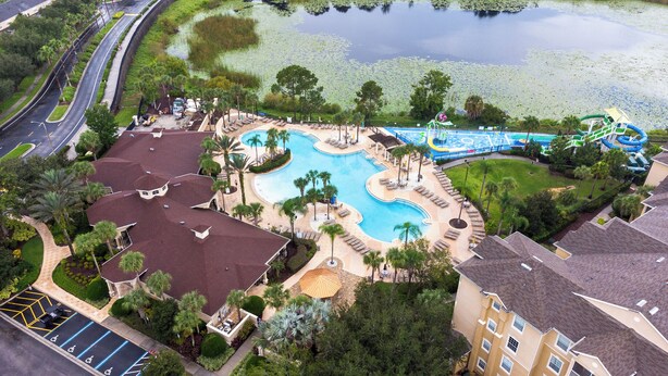 A resort with multiple swimming pools, a water park, and a parking area with handicapped accessible spaces. - Summer Dreams 3 Bed Condo in Windsor Hills Resort (Kissimmee)