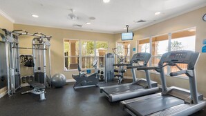 A gym with treadmills, exercise balls, and weight machines. - Summer Dreams 3 Bed Condo in Windsor Hills Resort (Kissimmee)