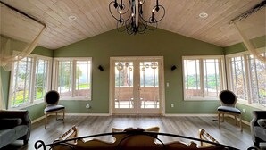 A spacious bedroom with a large bed, two chairs, and a chandelier. - Luxury vacation home, beautiful decor and views! natures 20 acre villa (Escondido)