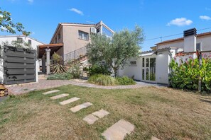 A residential property with a paved driveway, a staircase leading to a second floor, and a well-maintained garden with various plants. - Villa Above by Istrabook (Medulin)