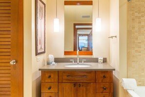 A bathroom with a wooden vanity, a large mirror, and a tiled shower area. - End of year specials! - BT701 Beautiful 3 Bed, 3 Bath (Kapolei)