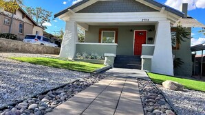 A residential house with a red door, number 2705, and a paved driveway leading to the entrance. - Casa Memphis Updated Modern Home (El Paso)
