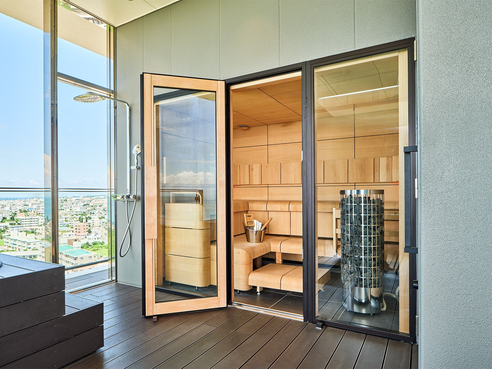 A modern bathroom with a glass door, wooden cabinets, and a visible shower area.