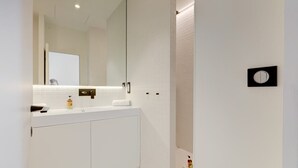 A modern bathroom with a white vanity, a large mirror, and a toilet. - Upstays Renovated 27m² Studio Near Palais (Cannes)