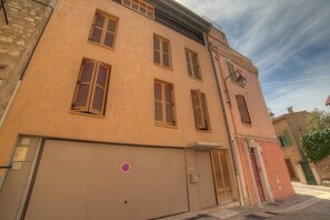 A building with multiple windows and a garage door.