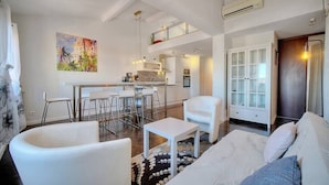 A modern apartment with a dining area, kitchen, and living room. - Upstays Port View 88m² Apartment Suquet (Cannes)