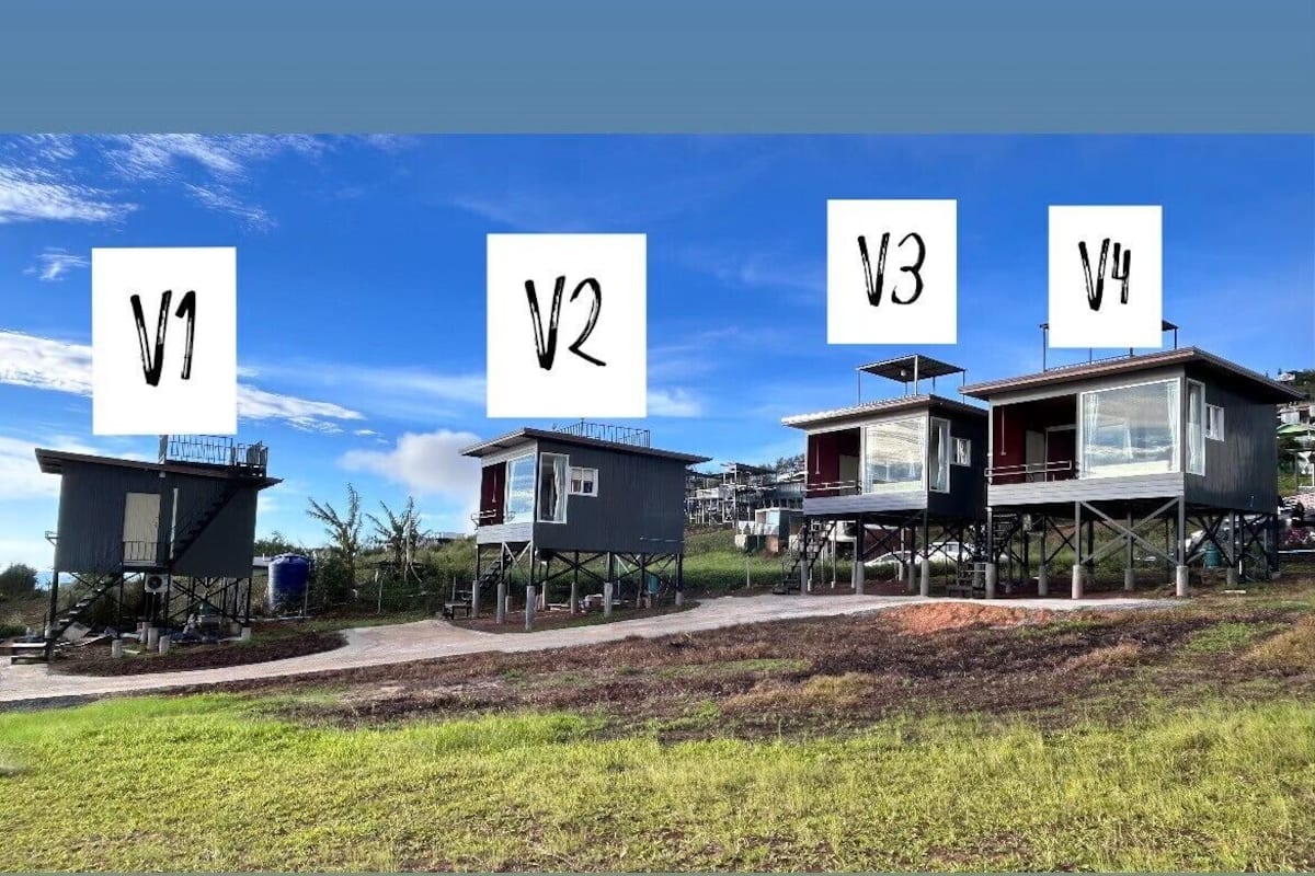 Four buildings labeled V1, V2, V3, and V4, each on stilts with a clear sky in the background.