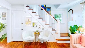 A staircase with white railings and wooden steps, leading to an upper floor.