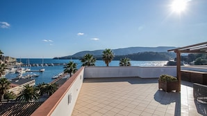 Una terraza con vistas a un puerto deportivo y al mar.