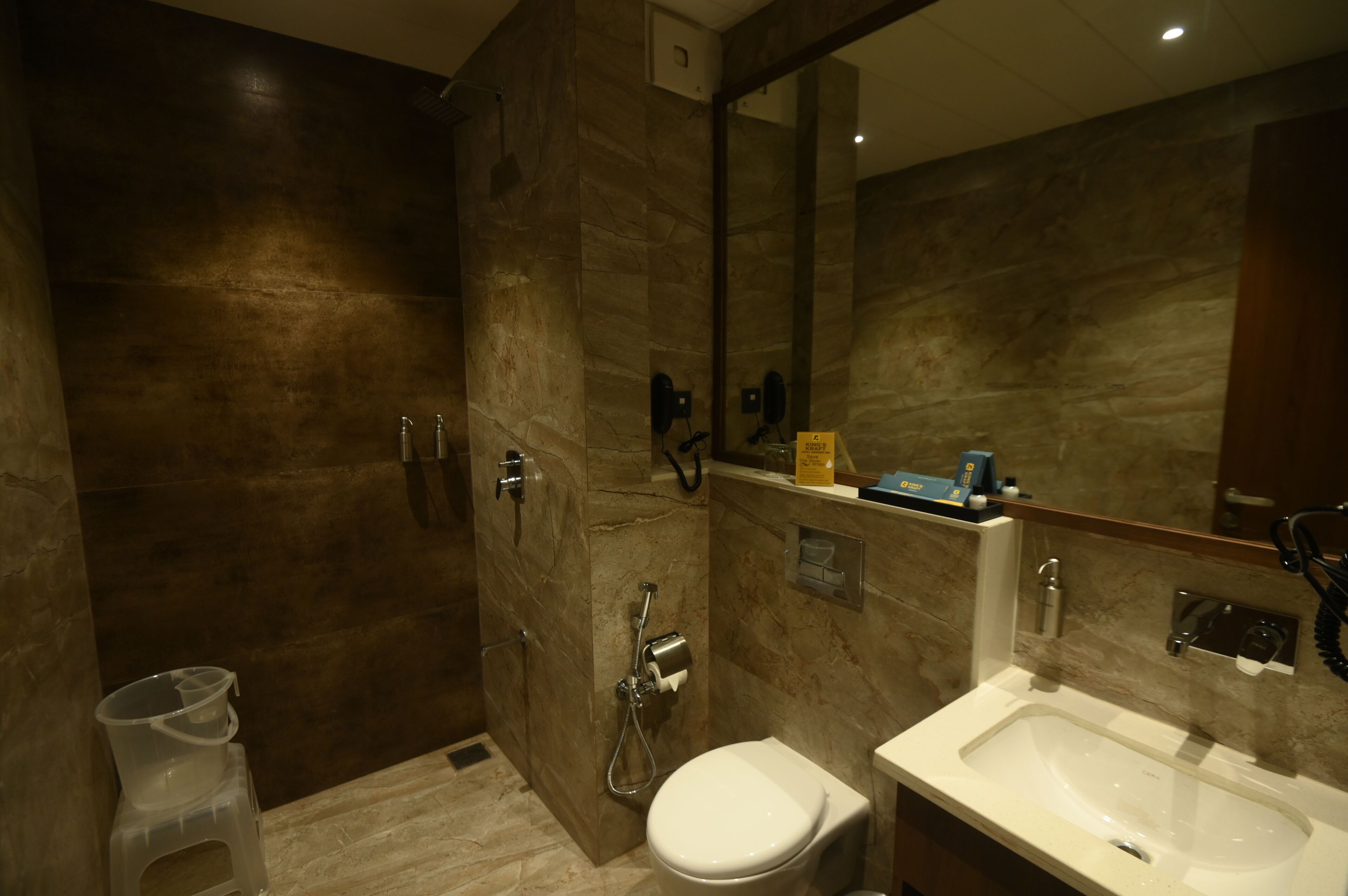 A modern bathroom with a shower, toilet, and sink.
