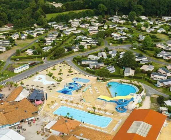 Relax by the pool surrounded by lush greenery and enjoy the resort's multiple pools, water slides, and wave pool.