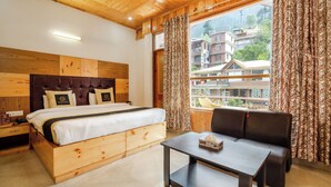 A wooden cabin-style room with a bed, a table, and a sofa. - Foxoso Cherry Hotel Manali (Manali)