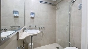 A modern bathroom with a glass-enclosed shower, two sinks, and a toilet. - Cozy Studio in Palermo with Private Patio! (Buenos Aires)